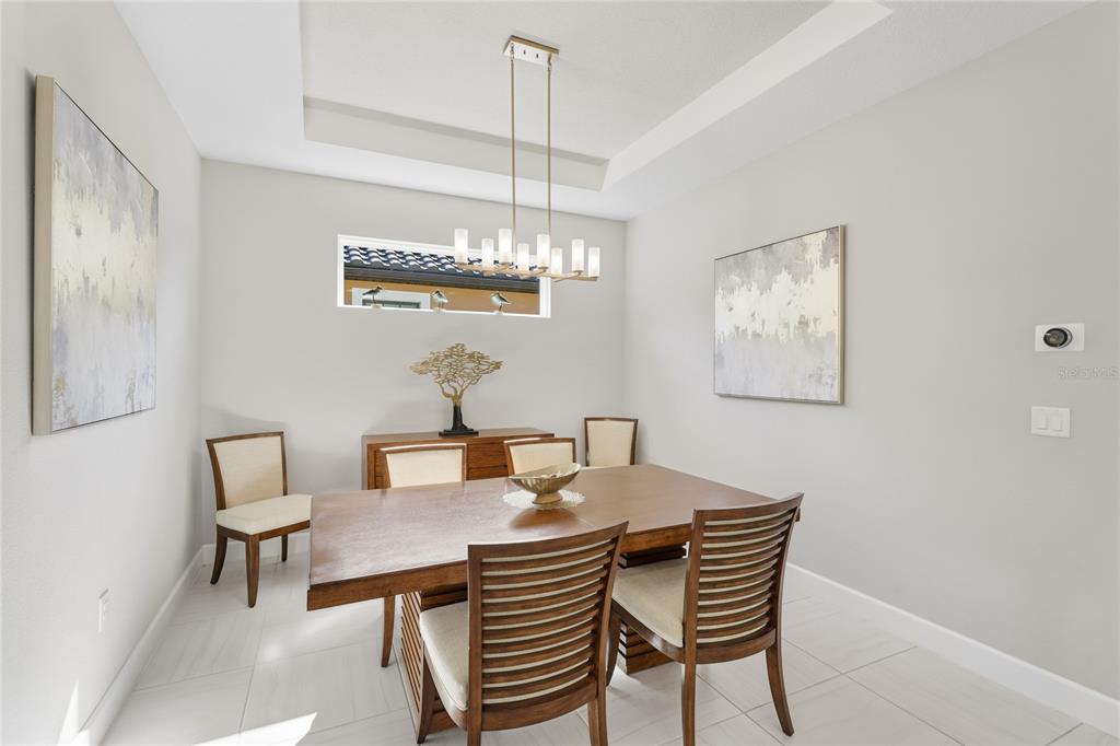 5804 Semolino Street Nokomis, FL 34275 - Photo 13 of 53 a view of a dining room with furniture and chandelier