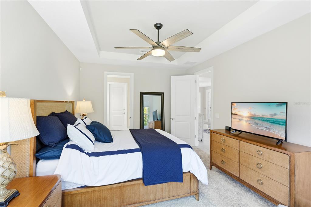 5804 Semolino Street Nokomis, FL 34275 - Photo 16 of 53 a bedroom with a bed and a flat screen tv