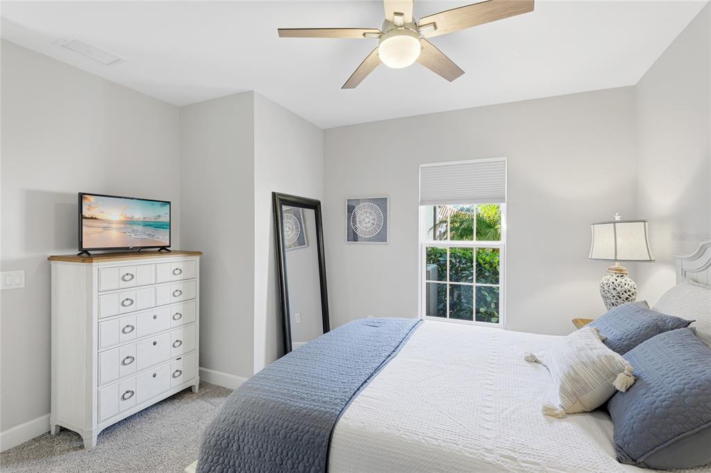 5804 Semolino Street Nokomis, FL 34275 - Photo 20 of 53 a bedroom with a bed and a flat tv screen