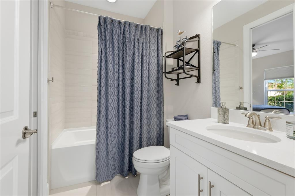 5804 Semolino Street Nokomis, FL 34275 - Photo 22 of 53 a bathroom with a sink a toilet and shower