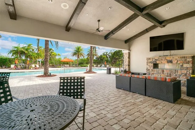 a view of house with swimming pool and green space
