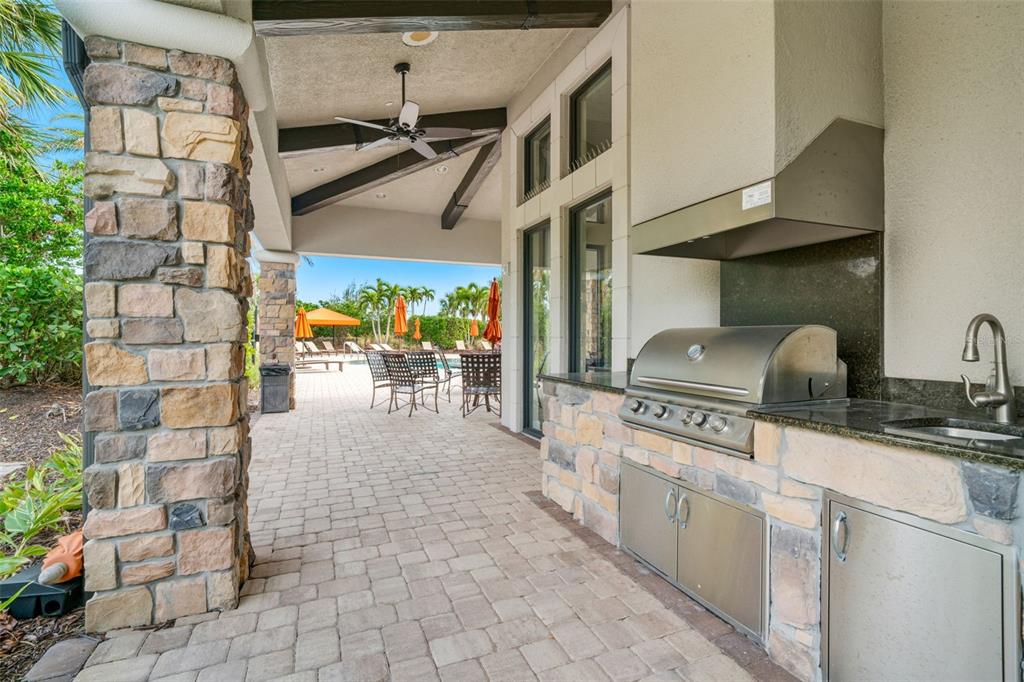 5804 Semolino Street Nokomis, FL 34275 - Photo 49 of 53 a kitchen with stainless steel appliances granite countertop a stove a sink and a refrigerator