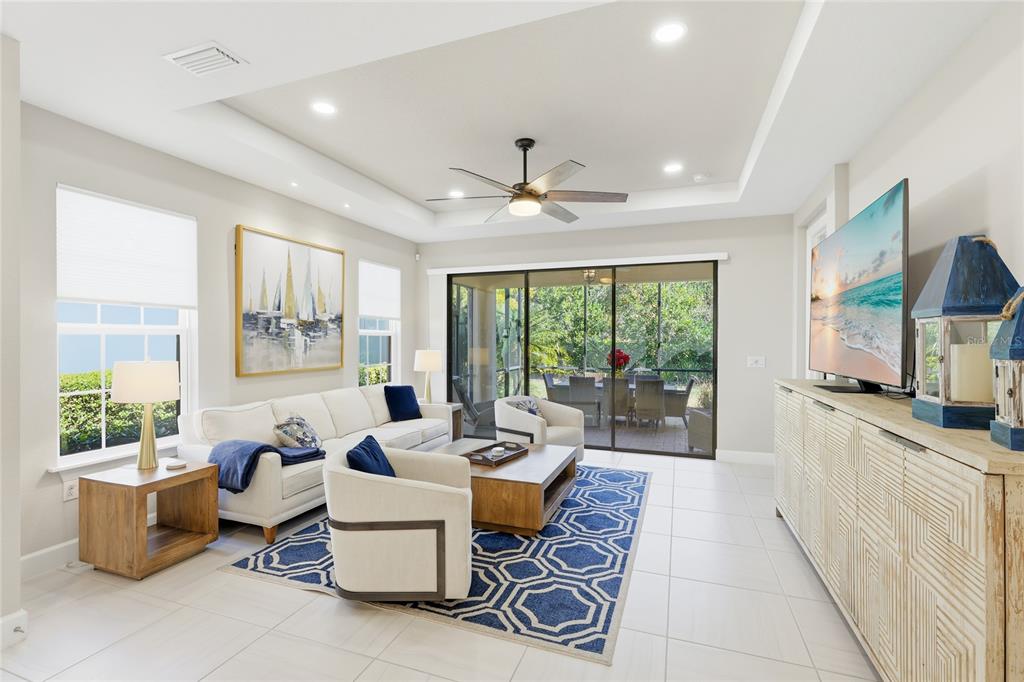 5804 Semolino Street Nokomis, FL 34275 - Photo 10 of 53 a living room with furniture a flat screen tv and a large window