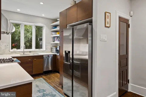 a stove top oven sitting inside of a kitchen