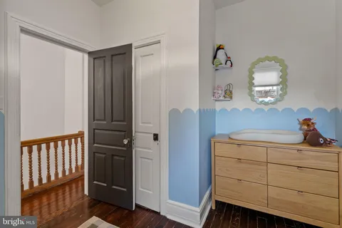 a bedroom with a bed and a television