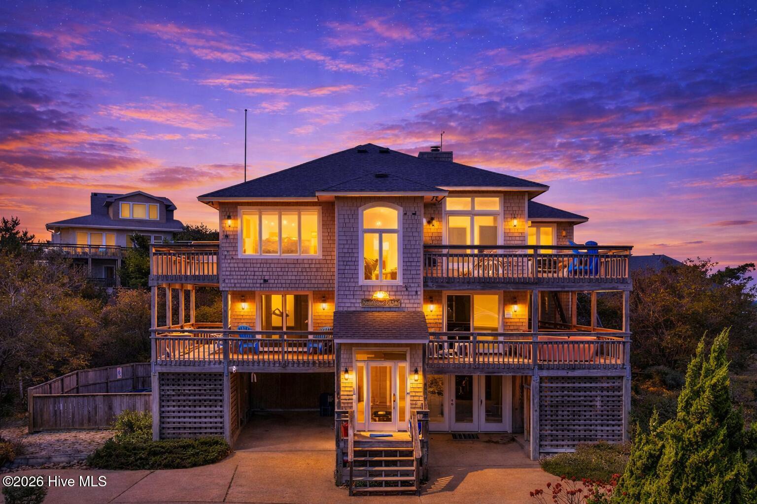 116 Snipe Court Duck, NC 27949 - Photo 16 of 49 Coastal house at dusk with warm lighting
