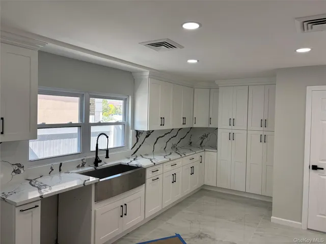 a picture of a bench in front of a wall