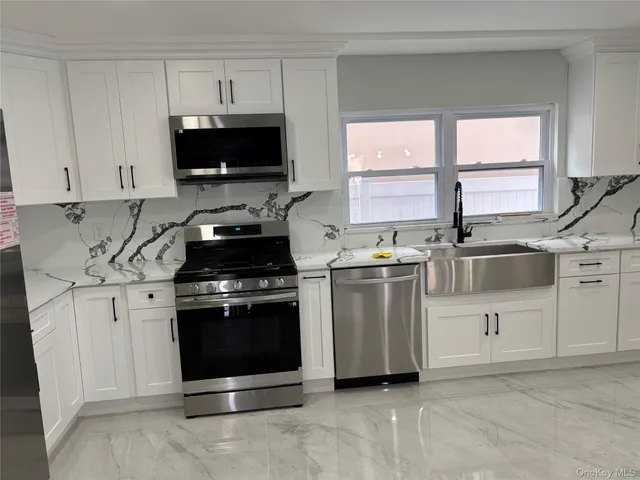 a large bathroom with a double vanity sink mirror and shower
