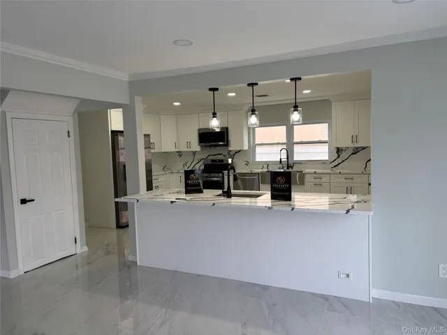 a kitchen that has a sink cabinets and stainless steel appliances