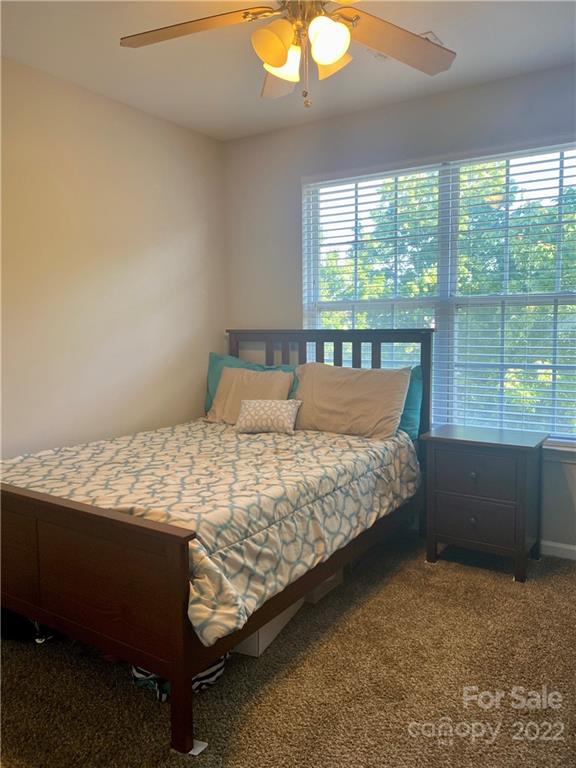 514 Bent Leaf Court, Unit 11 Fort Mill, SC 29708 - Photo 14 of 22 a bed sitting in a bedroom next to a window