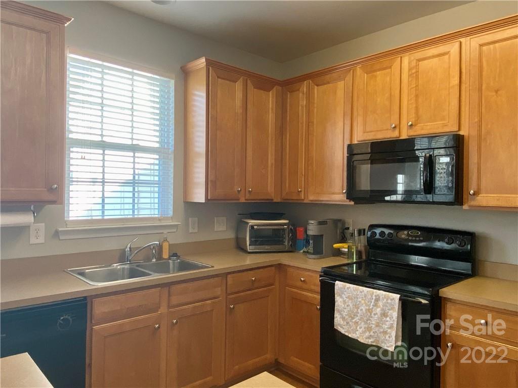 514 Bent Leaf Court, Unit 11 Fort Mill, SC 29708 - Photo 6 of 22 a kitchen with a sink a stove and cabinets