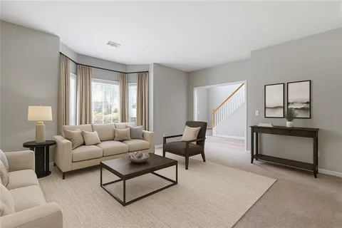 an empty room with windows and ceiling fan