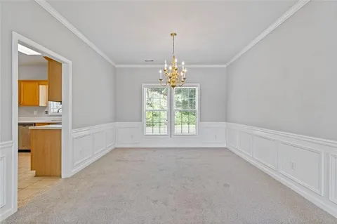 a living room with furniture a fireplace and a large window