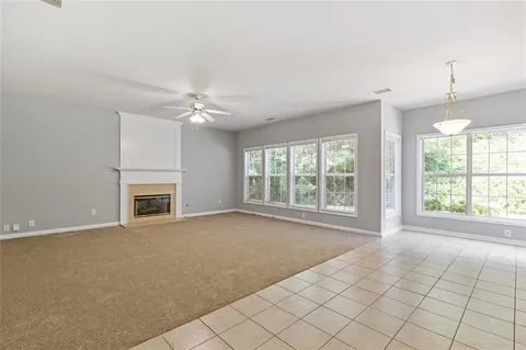 a kitchen with a refrigerator a sink dishwasher with a dining table and chairs