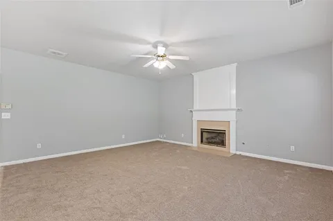 a view of a dining room with furniture and a chandelier