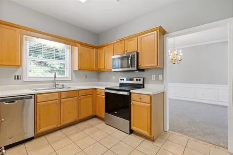 a kitchen with a stove a sink and a refrigerator