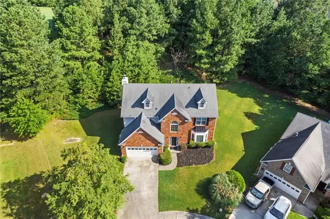 an aerial view of a house with swimming pool and outdoor space
