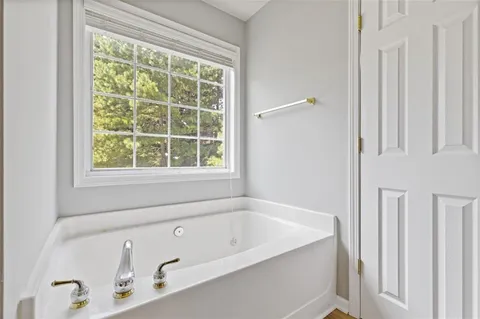 an aerial view of a house with a garden and lake view