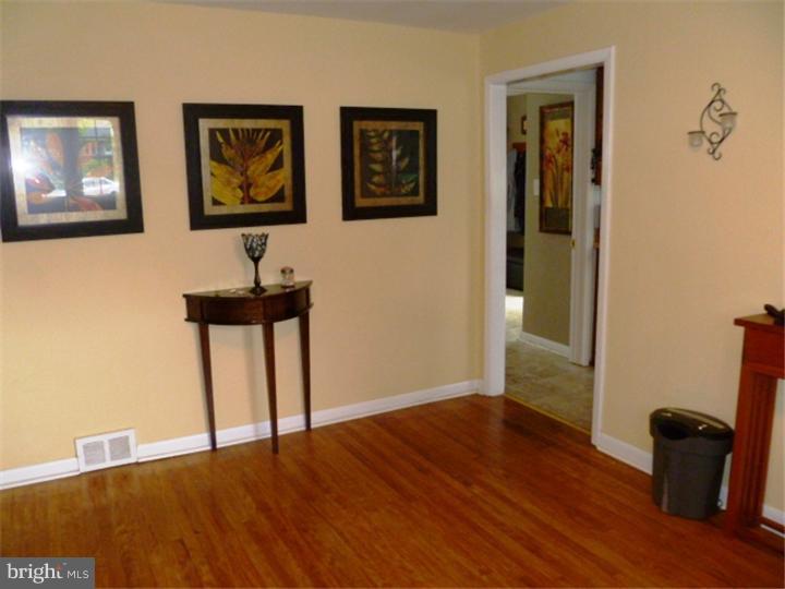 10 Briar Road Cherry Hill, NJ 08034 - Photo 13 of 25 a view of an empty room with wooden floor and a window
