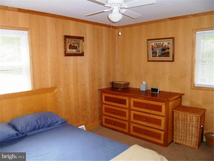 10 Briar Road Cherry Hill, NJ 08034 - Photo 16 of 25 a room with a bed and a chandelier