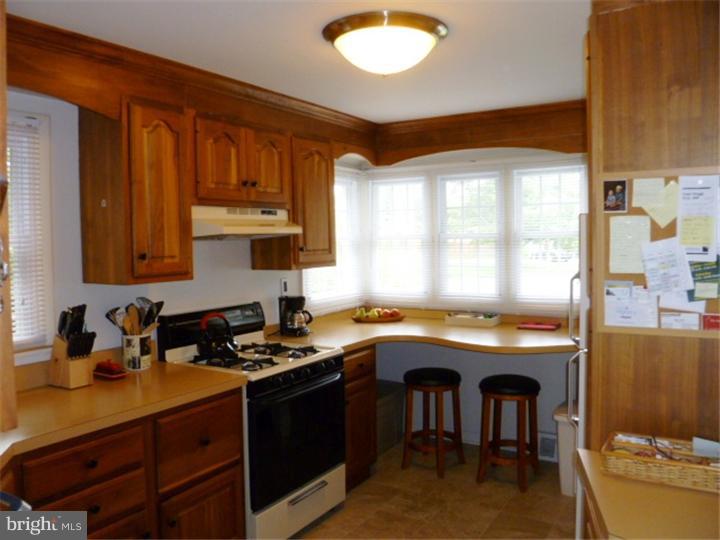 10 Briar Road Cherry Hill, NJ 08034 - Photo 7 of 25 a kitchen with a sink stove and cabinets