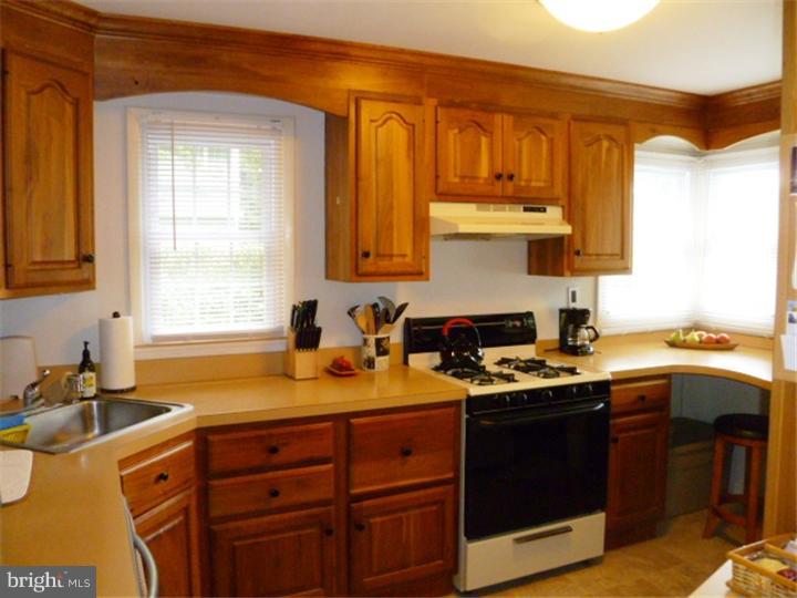 10 Briar Road Cherry Hill, NJ 08034 - Photo 8 of 25 a kitchen with a sink stove top oven and cabinets