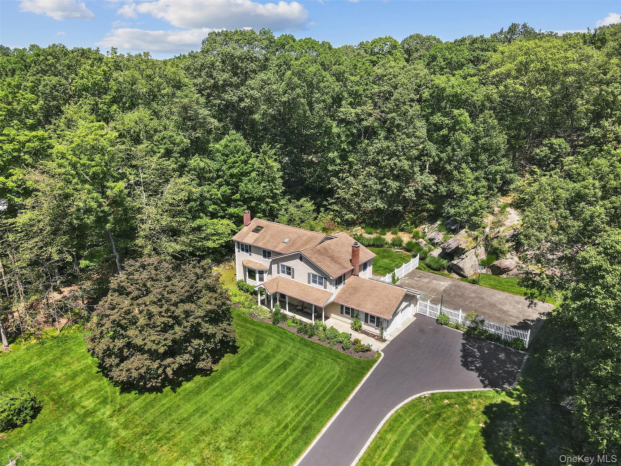 an aerial view of a house with garden space and street view