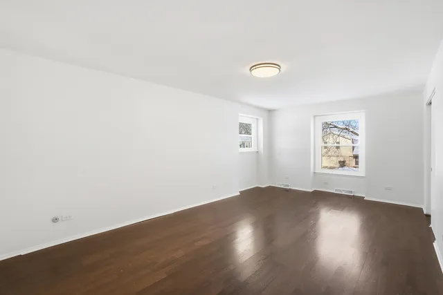 a spacious bathroom with a double vanity sink a large mirror and a bathtub