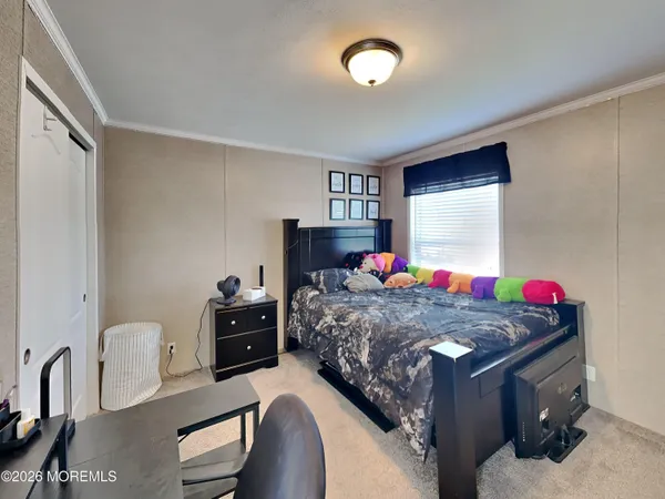 a bedroom with furniture and a flat screen tv