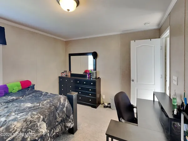 a bedroom with a bed and a dresser in it