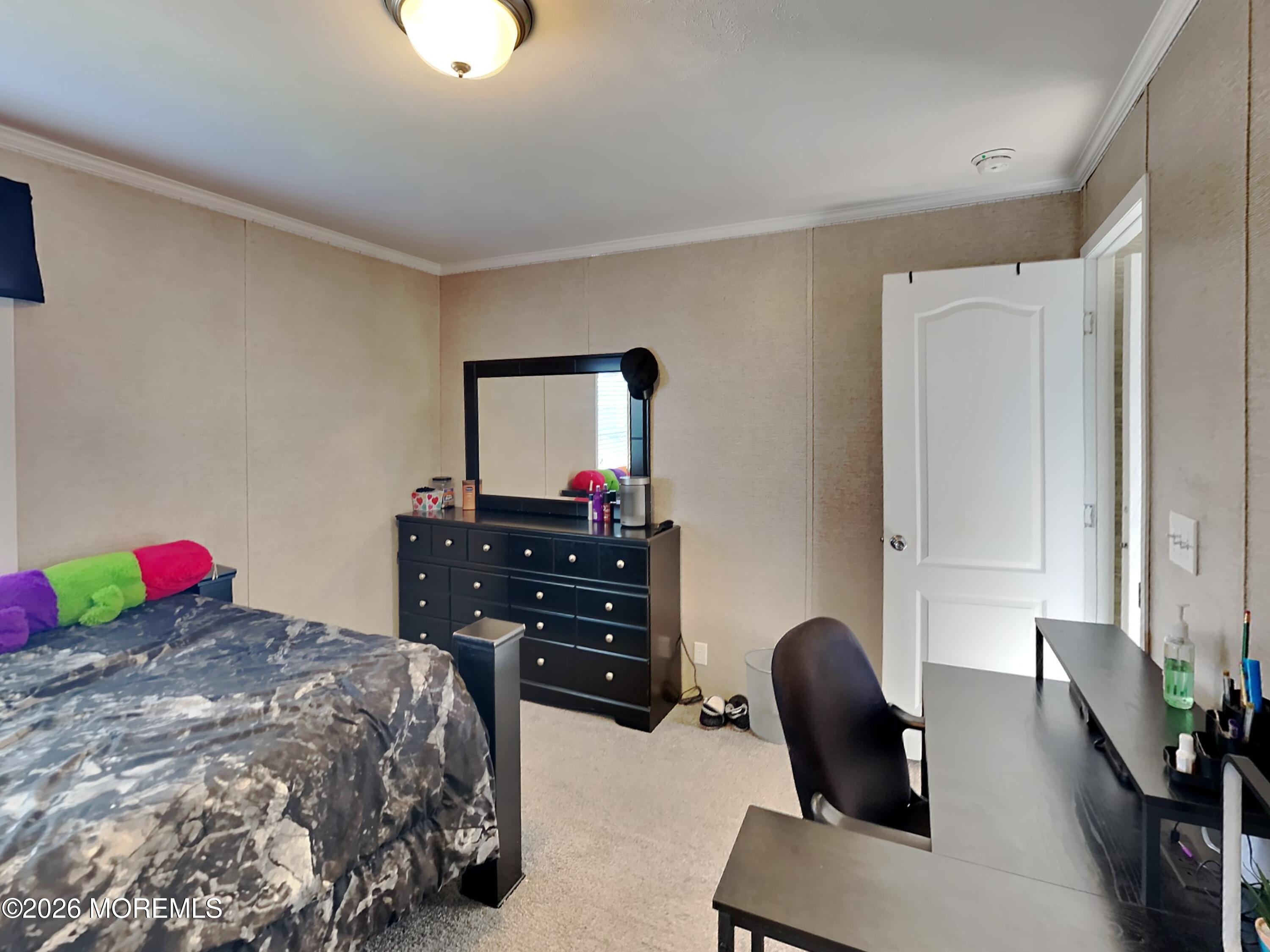 411 4th Street Jackson, NJ 08527 - Photo 13 of 15 a bedroom with a bed and a dresser in it