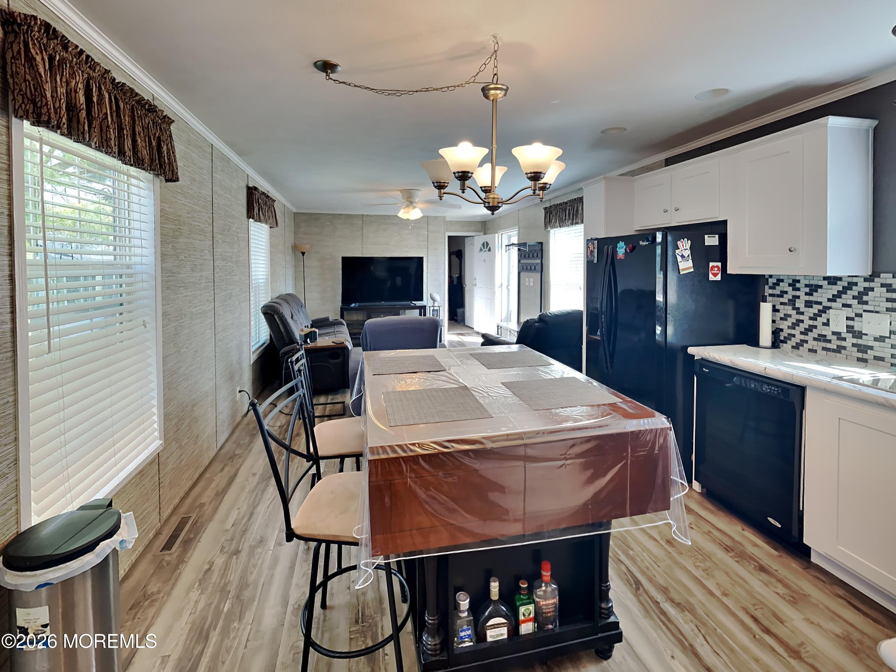 411 4th Street Jackson, NJ 08527 - Photo 5 of 15 a view of a dining room with furniture a chandelier and wooden floor