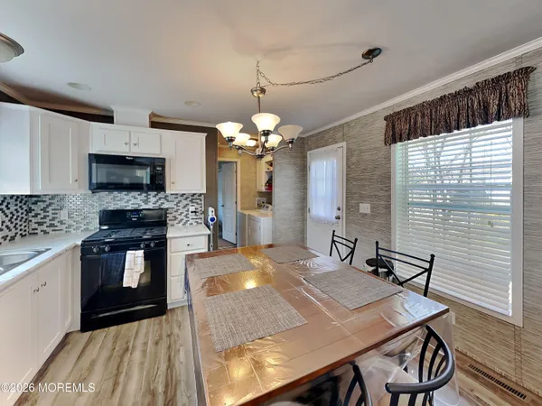 a kitchen with a table chairs sink and microwave