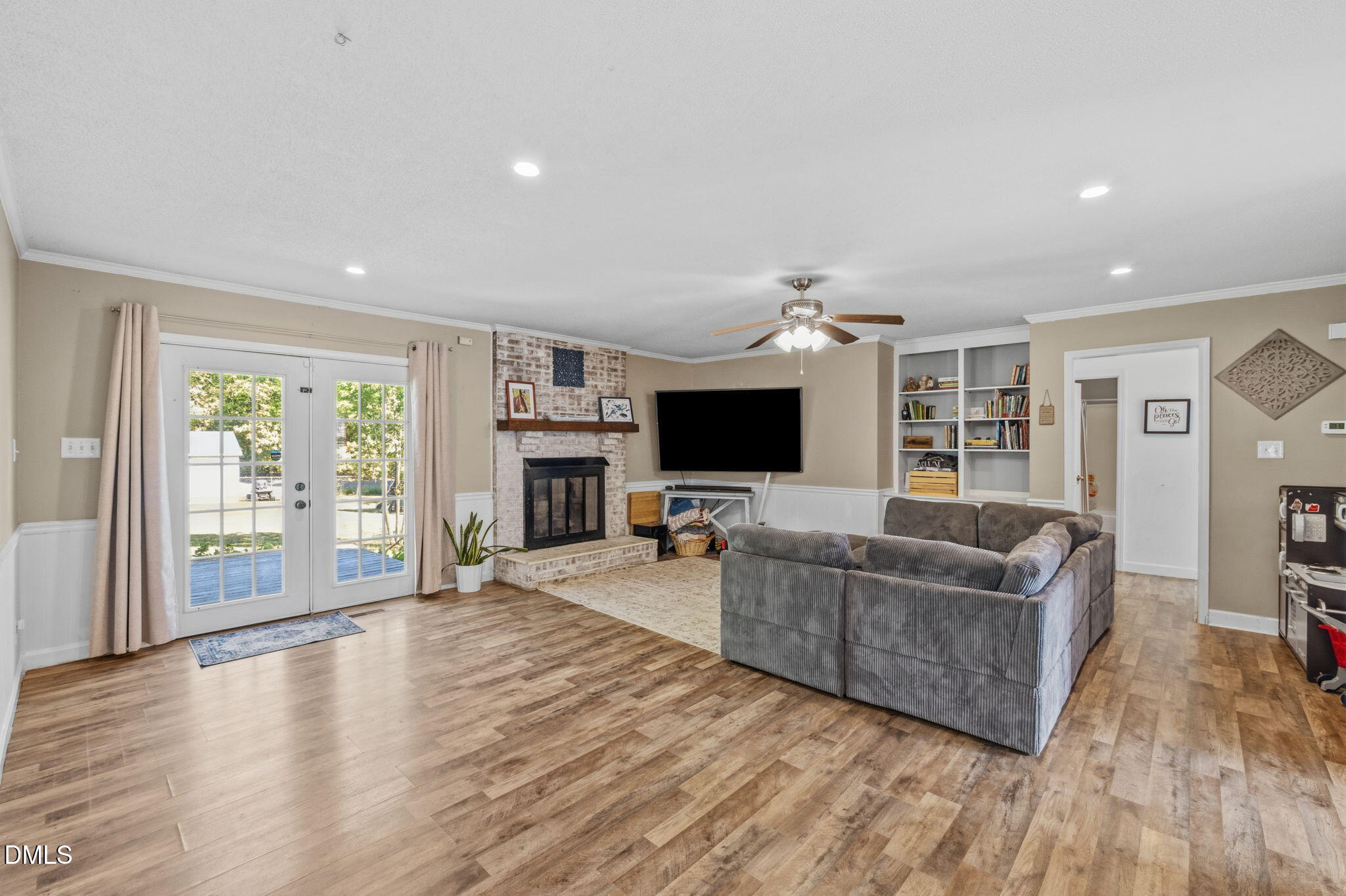 107 East F Street Butner, NC 27509 - Photo 15 of 47 a living room with furniture a flat screen tv and a fireplace