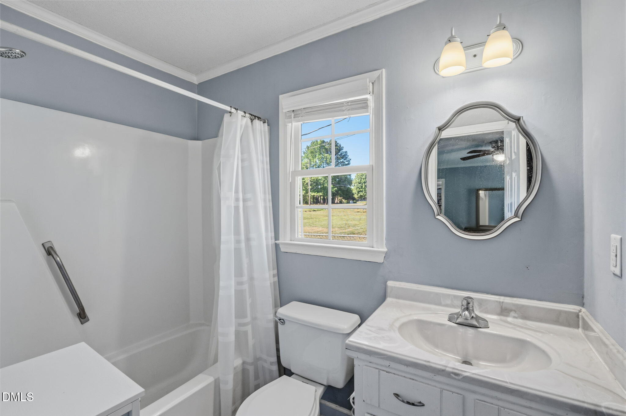 107 East F Street Butner, NC 27509 - Photo 22 of 47 a bathroom with a toilet a sink and a mirror