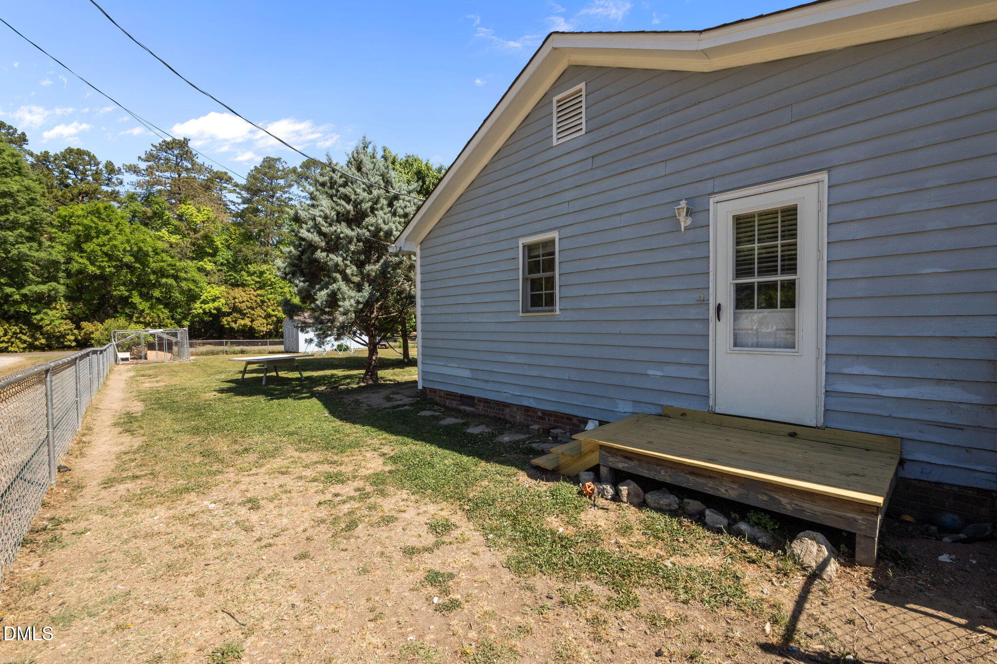 107 East F Street Butner, NC 27509 - Photo 30 of 47 a view of a backyard with chairs and a small yard