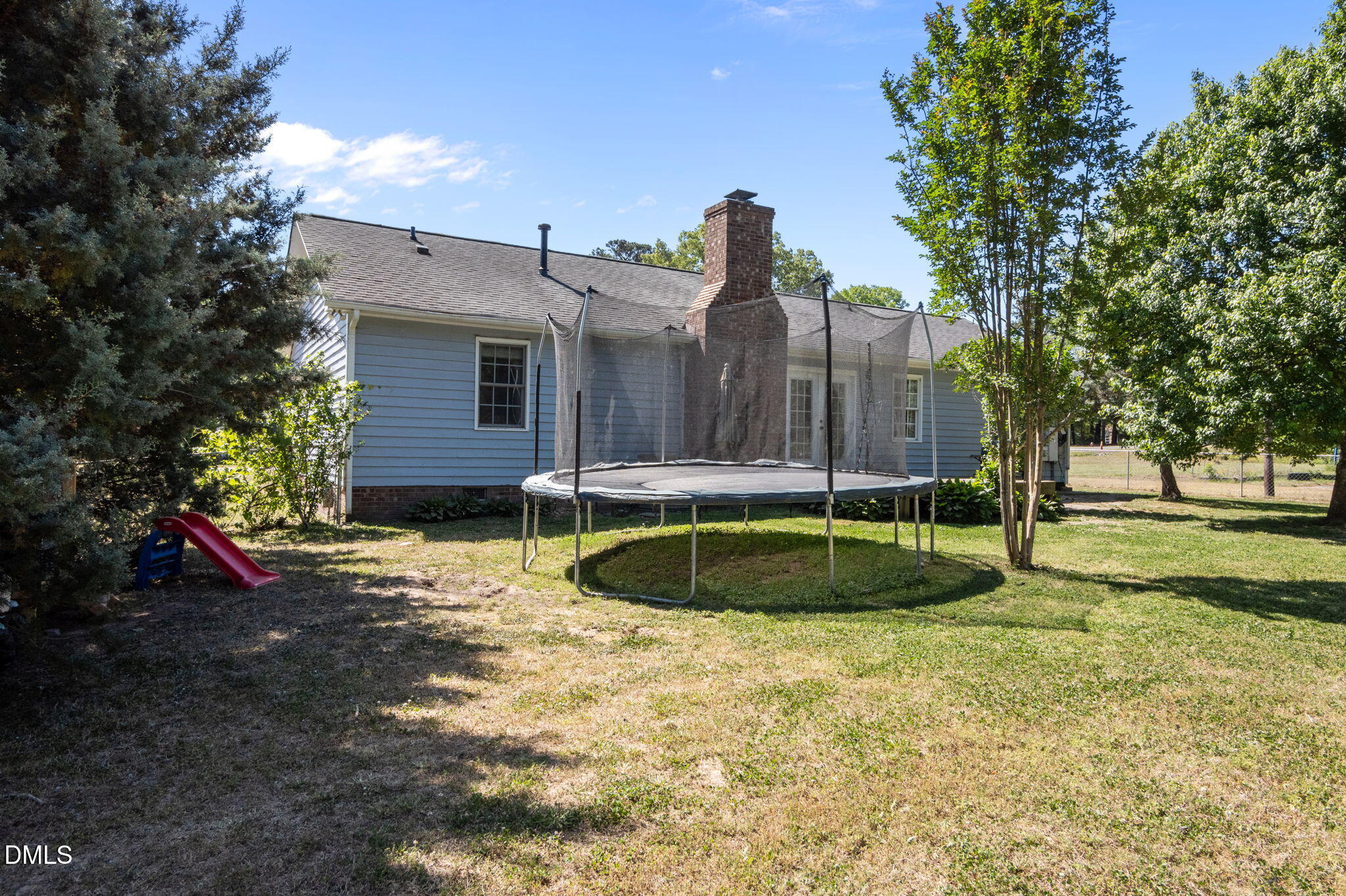 107 East F Street Butner, NC 27509 - Photo 33 of 47 a view of a house with a yard and a large tree