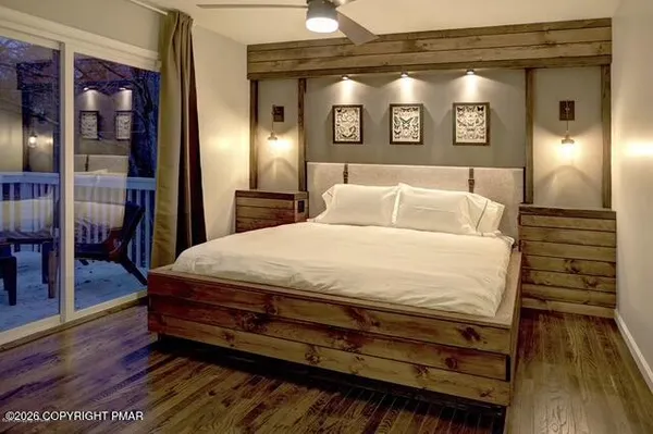 a large bed sitting in a room next to a lamp