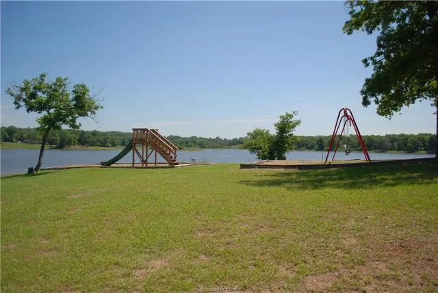 a view of a swimming pool with a yard