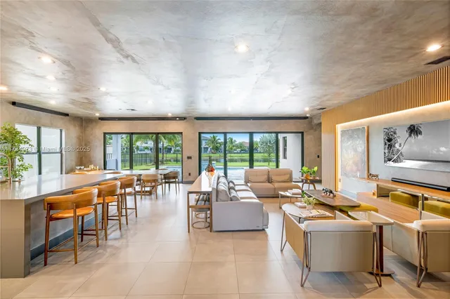 a living room with furniture and large windows