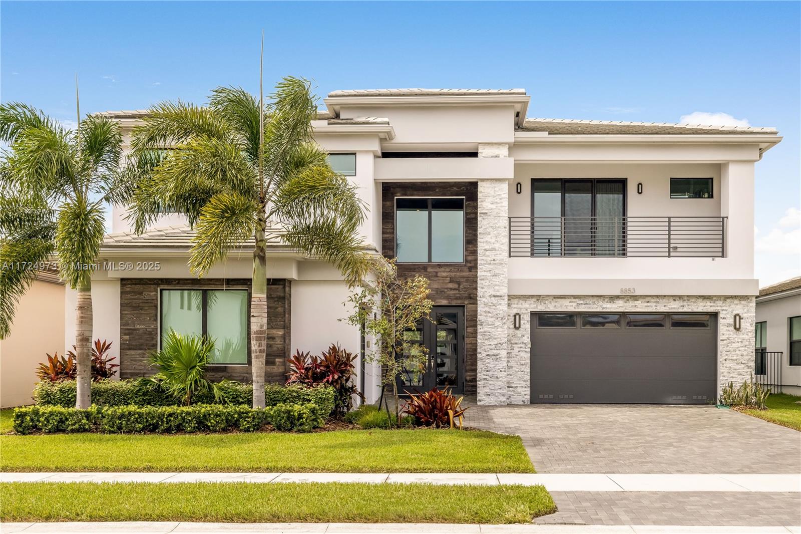 8853 New River Falls Road Boca Raton, FL 33496 - Photo 3 of 35 a front view of a house with a garden