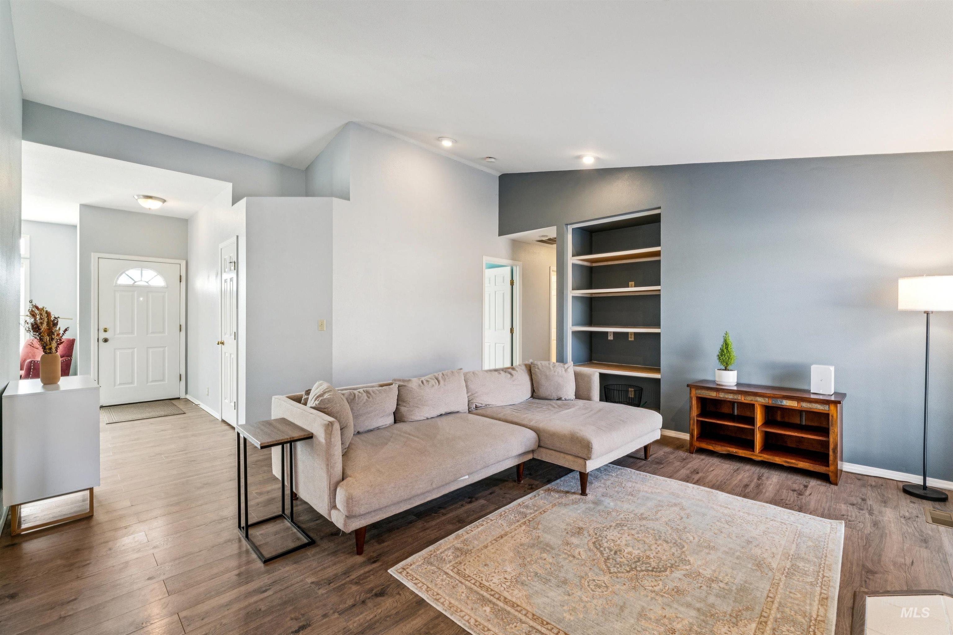 11968 West Bronte Street Boise, ID 83709 - Photo 12 of 48 Living room with wood finished floors, vaulted ceiling, and built in features