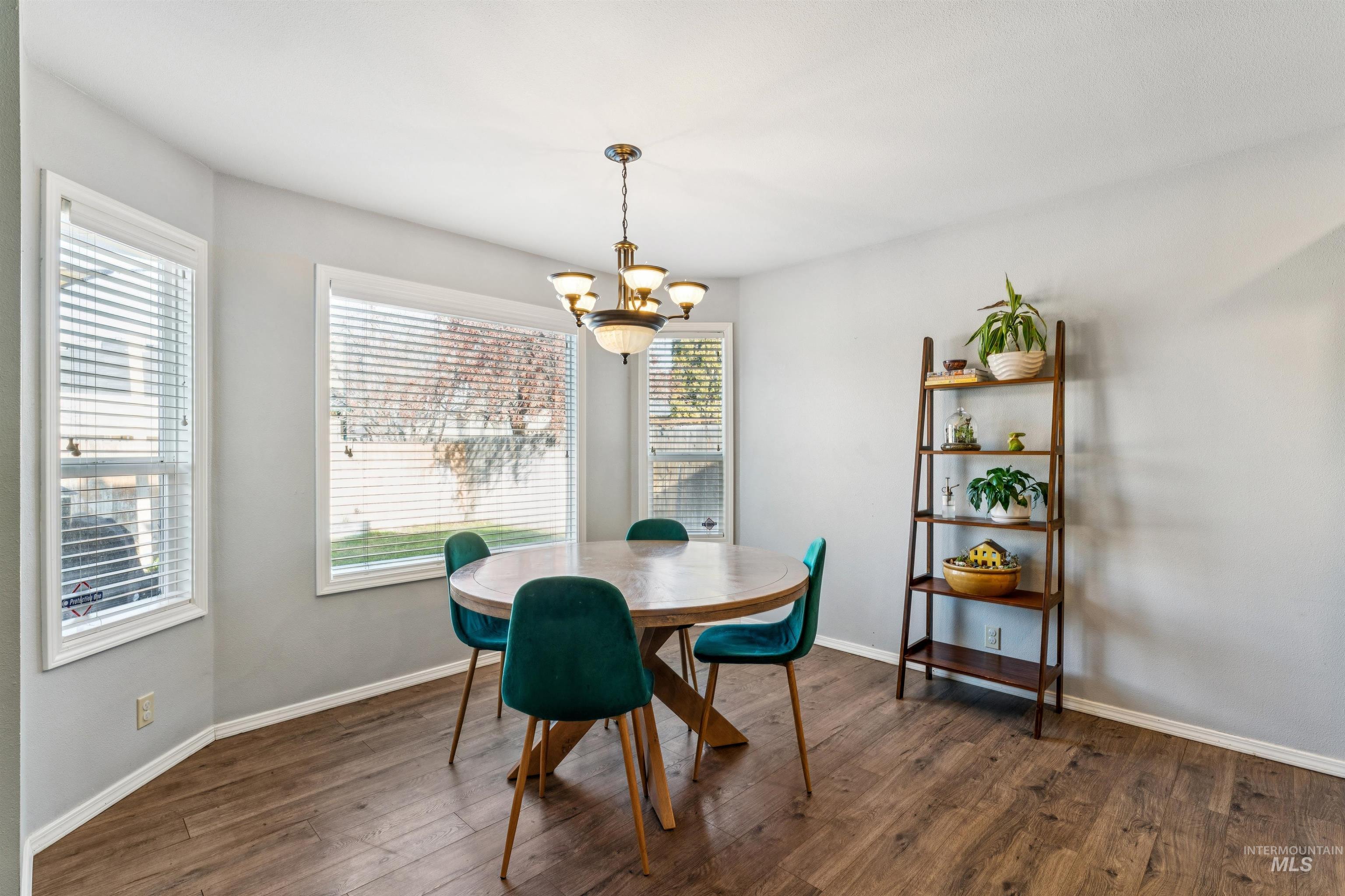 11968 West Bronte Street Boise, ID 83709 - Photo 16 of 48 Dining space with dark wood finished floors and a chandelier