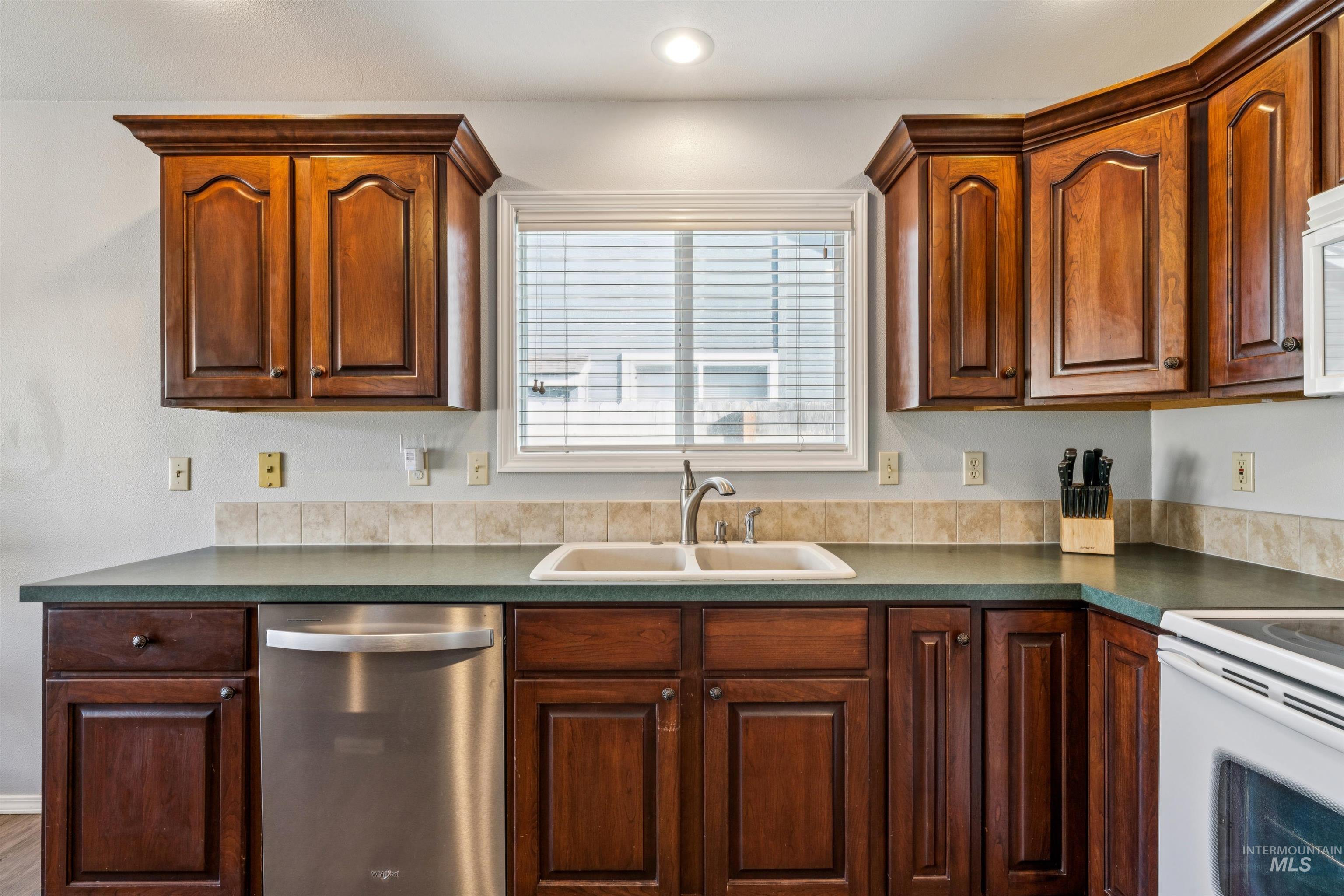 11968 West Bronte Street Boise, ID 83709 - Photo 18 of 48 Kitchen featuring dishwasher, white electric range oven, and dark countertops
