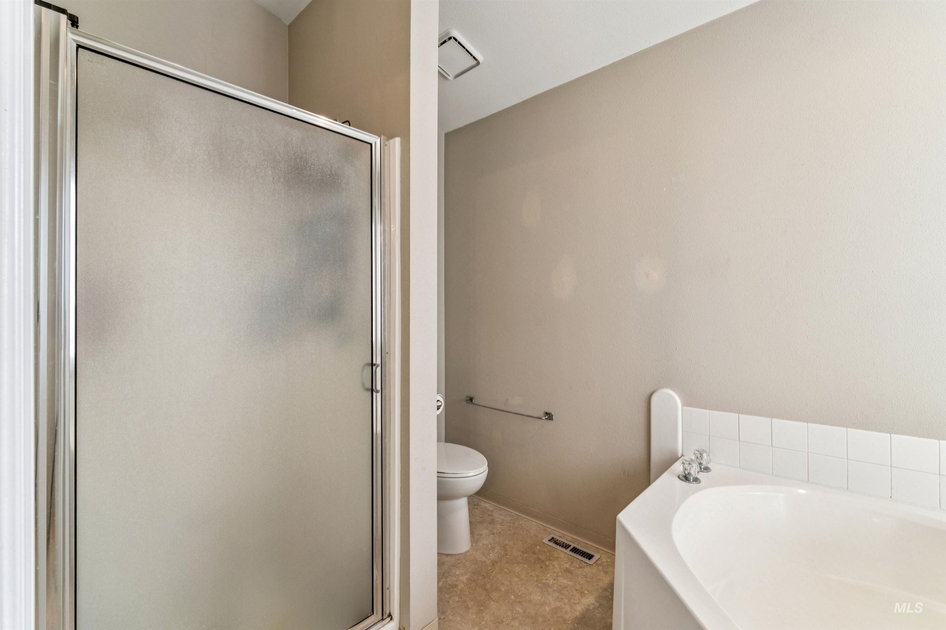 11968 West Bronte Street Boise, ID 83709 - Photo 26 of 48 Full bathroom featuring a bath and a stall shower
