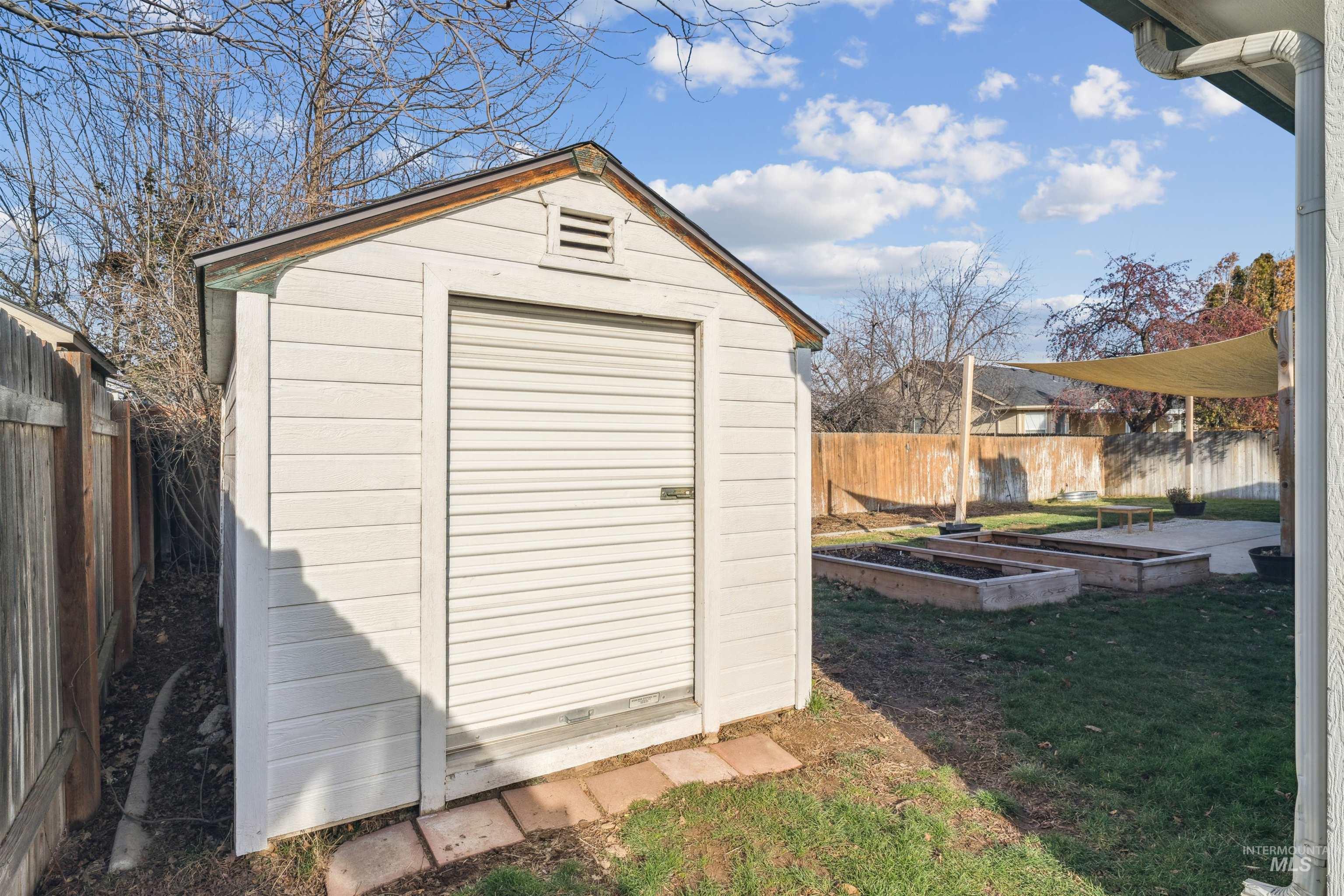 11968 West Bronte Street Boise, ID 83709 - Photo 40 of 48 View of shed with a fenced backyard and a garden