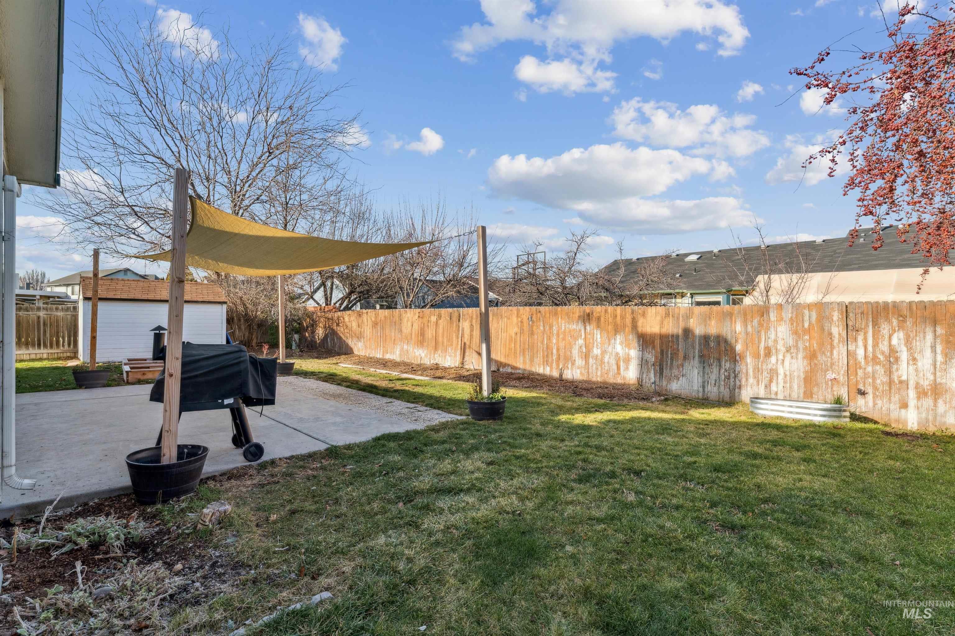 11968 West Bronte Street Boise, ID 83709 - Photo 42 of 48 Fenced backyard with a patio area and an outdoor structure