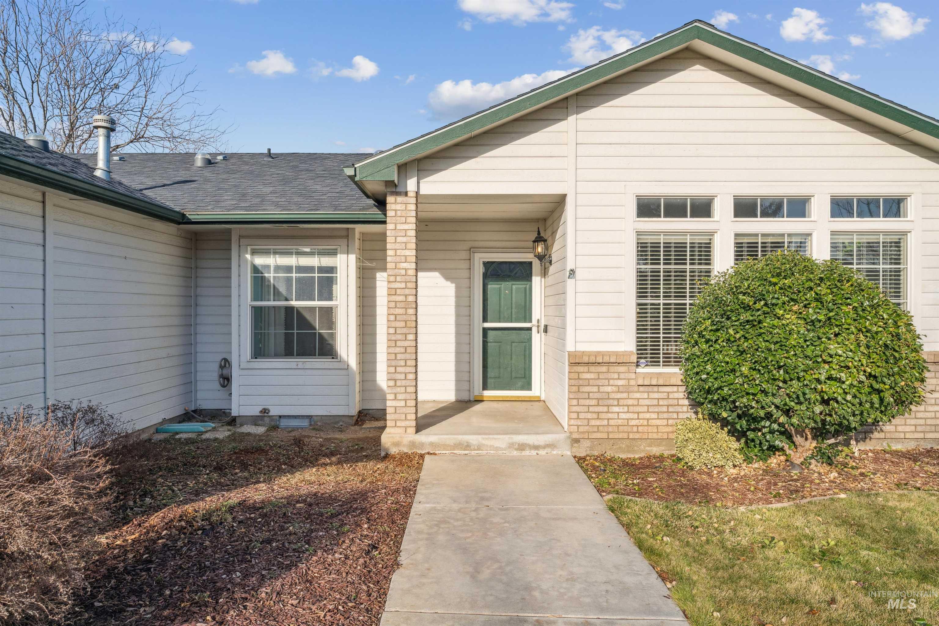 11968 West Bronte Street Boise, ID 83709 - Photo 6 of 48 Entrance to property featuring roof with shingles and brick siding