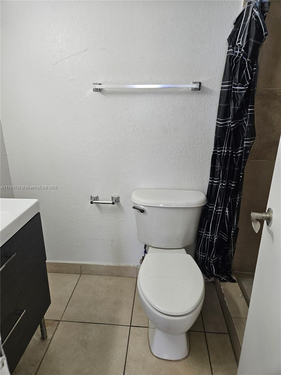 1805 Sans Souci Boulevard, Unit 302R North Miami, FL 33181 - Photo 11 of 33 a white toilet sitting next to a shower