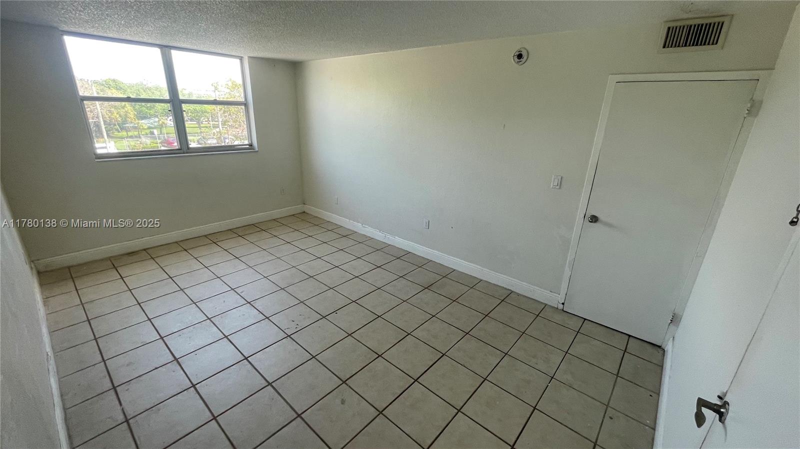1805 Sans Souci Boulevard, Unit 302R North Miami, FL 33181 - Photo 14 of 33 a view of an empty room and window